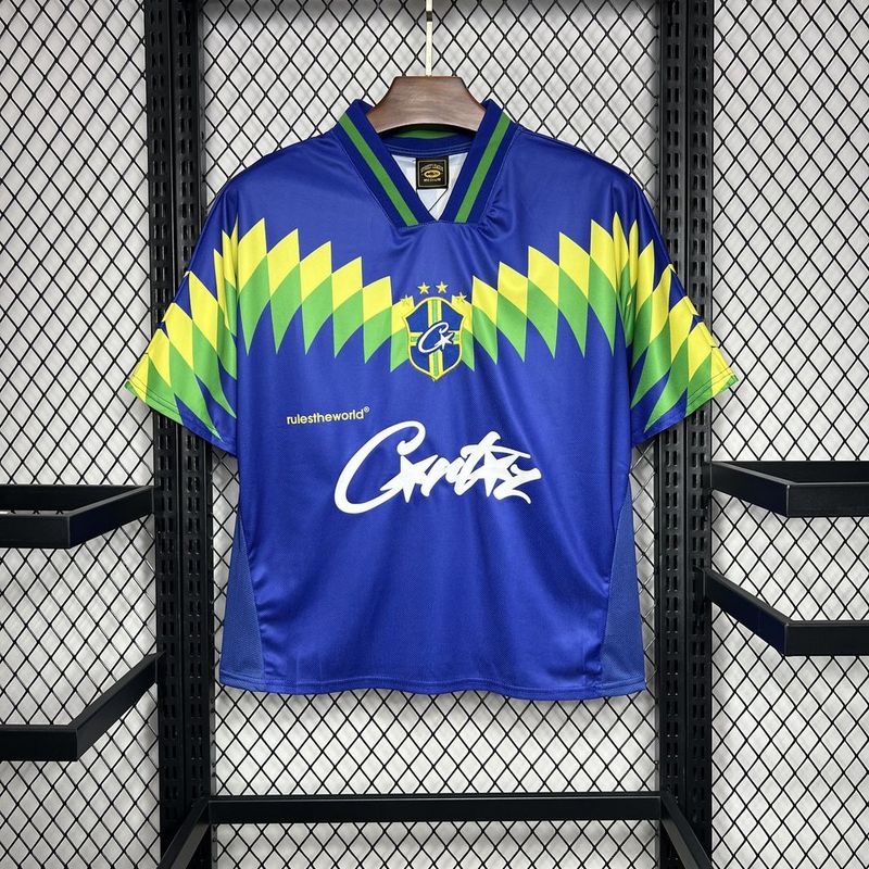 Mens Brazil Corteiz Retro Away Jersey 1995 Mens Brazil Corteiz Retro Away Jersey 1995 on hanger showing blue body with lime green saw-tooth chevron graphics