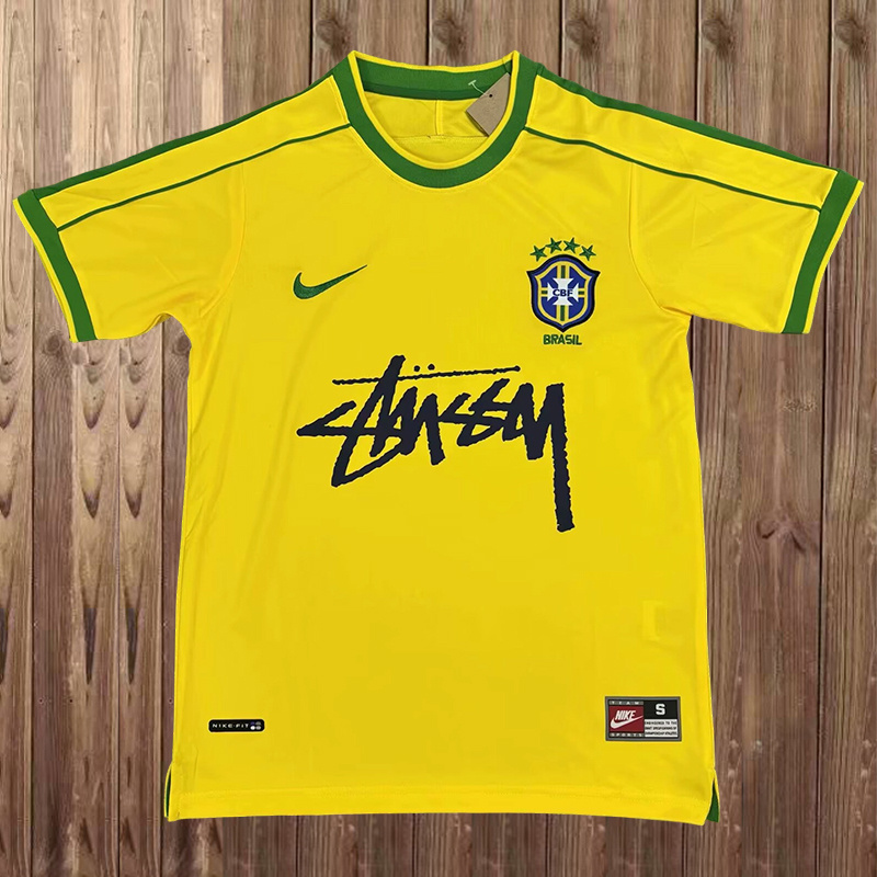Mens World Cup Brazil Signed Edition Yellow Retro Home Jersey 1998 Mens World Cup Brazil Signed Edition Yellow Retro Home Jersey 1998 flat view showing yellow body and signature script