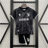 Kids Vitoria SC Away Kit 2025/26 on rack showing charcoal black geometric jersey with white trims and matching shorts