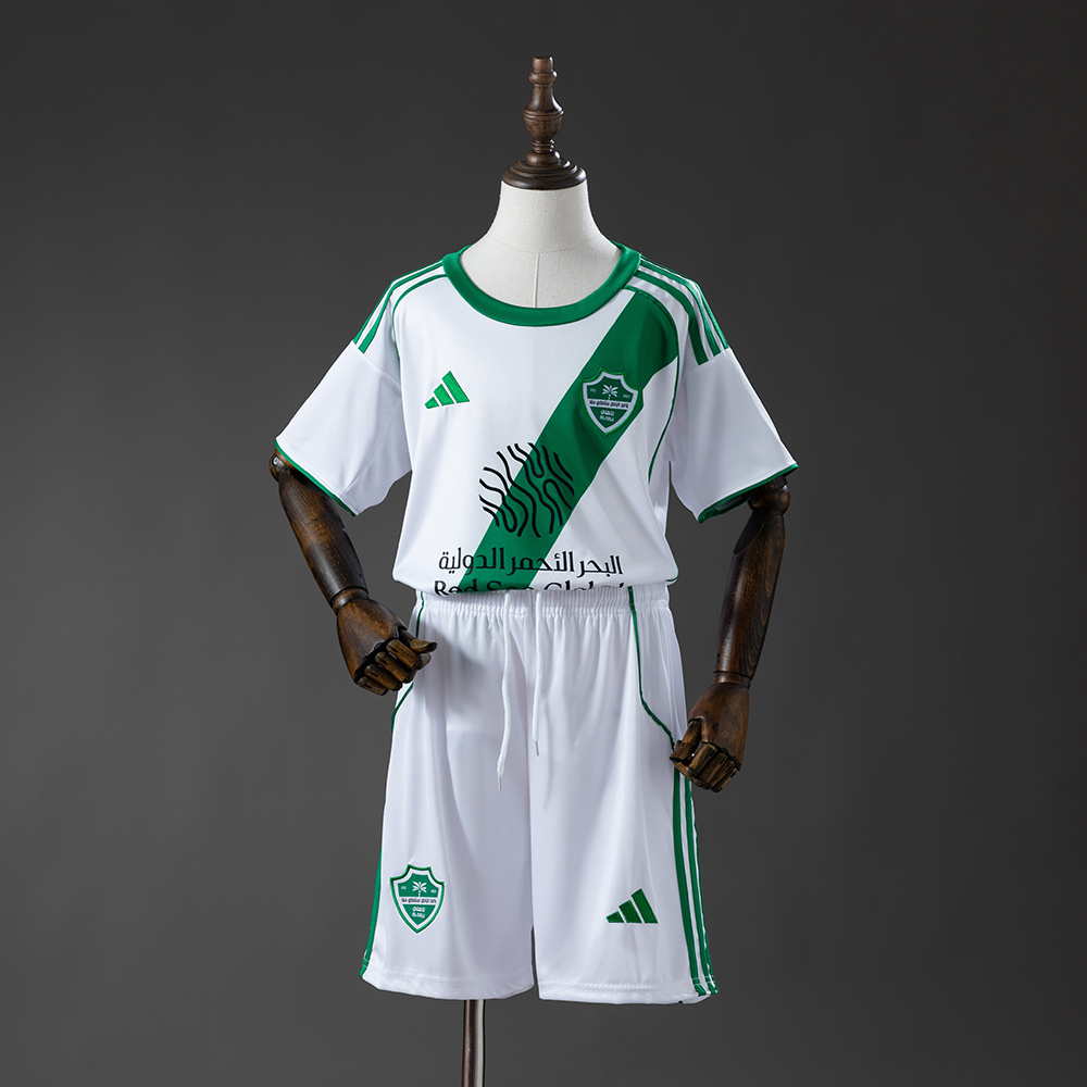 Kids Al/Ahli Saudi Away Kit 2025/26 Kids Al/Ahli Saudi Away Kit 2025/26 on mannequin showing white jersey with green diagonal sash and shorts