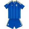 Front view of Kids World Cup Sweden Away Kit 2026 shirt and shorts set in royal blue with yellow accents