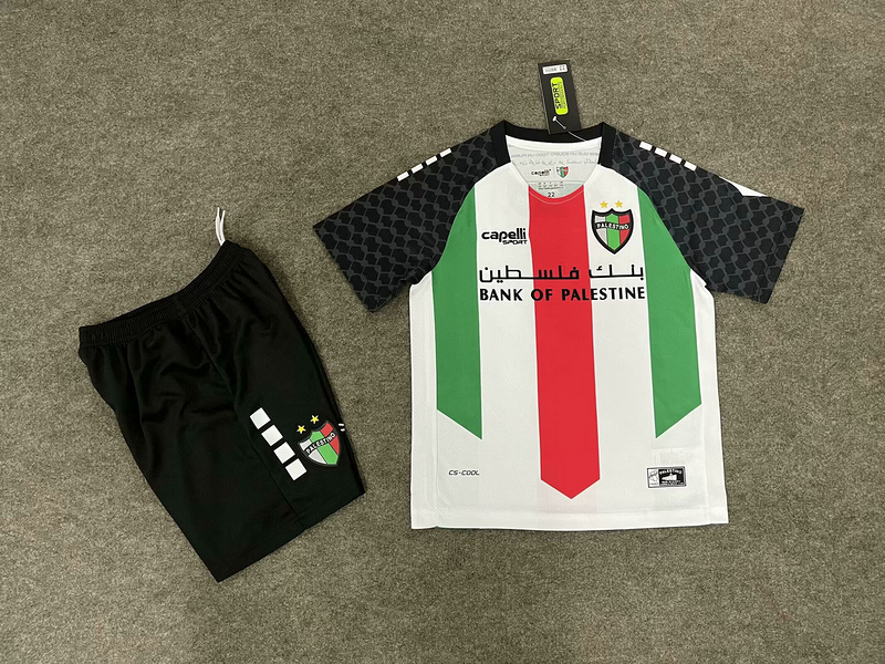Kids Palestino Home Kit 2025/26 Kids Palestino Home Kit 2025/26 front view with tricolor jersey, keffiyeh sleeves, and black shorts