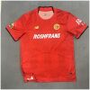 Mens Toluca Home Jersey 2025/26 front view in scarlet red with tonal stripes and Roshfrans sponsor