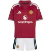 Kids Manchester United Home Kit 2026/27 front view with red polo jersey, white shorts, and Snapdragon sponsor