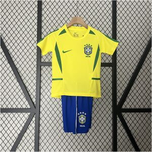 Front view of the Kids World Cup Brazil Retro Home Kit 2002 featuring yellow jersey and royal blue shorts