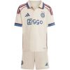Cream kids Ajax third kit shirt with blue cuffs and Ziggo print front view