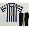 Kids Newcastle United Retro Home Kit 1997/99 jersey and shorts set flat lay view