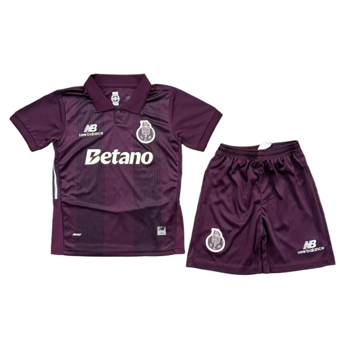 Kids FC Porto Away Kit 2026/27 Kids FC Porto Away Kit 2026/27 front view with plum polo and shorts