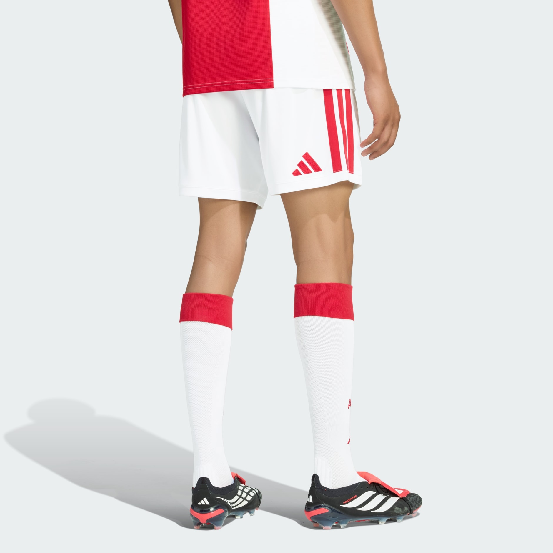 Mens Ajax Home Shorts 2026/27 Mens Ajax Home Shorts 2026/27 white shorts back view showing red adidas logo and side stripes on model