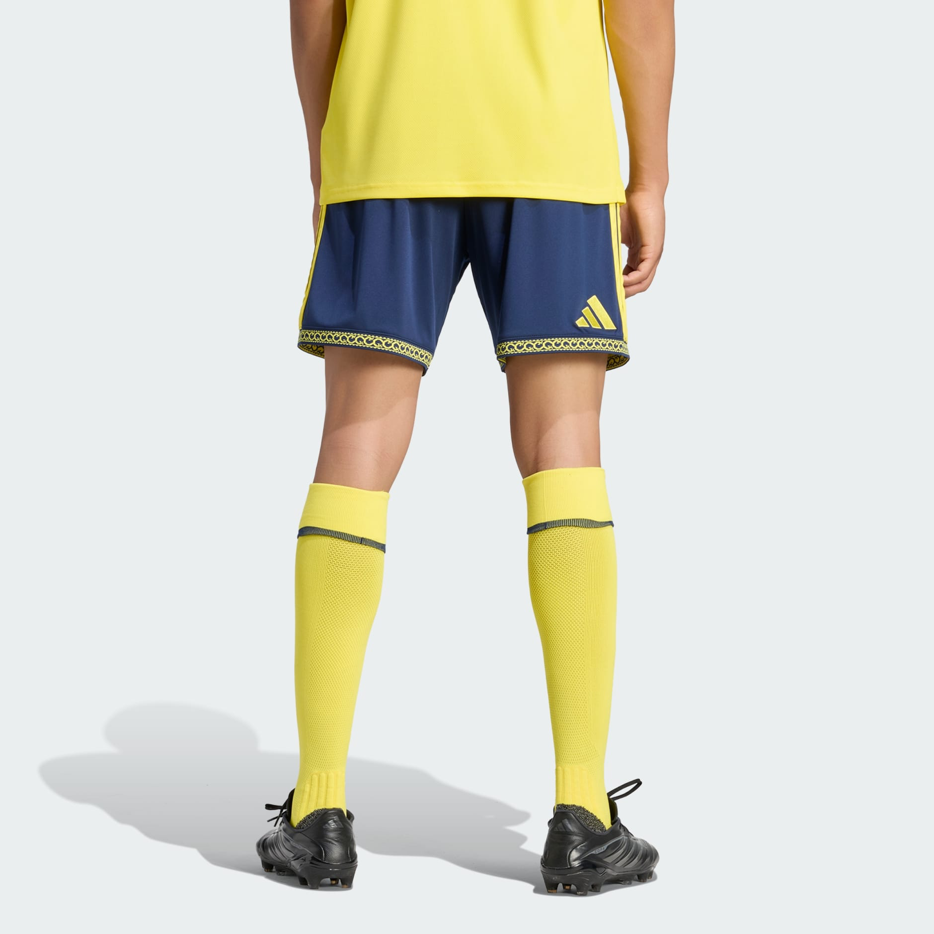 Mens Al Nassr Home Shorts 2026/27 Mens Al Nassr Home Shorts 2026/27 navy shorts rear view showing yellow adidas logo and patterned hem border