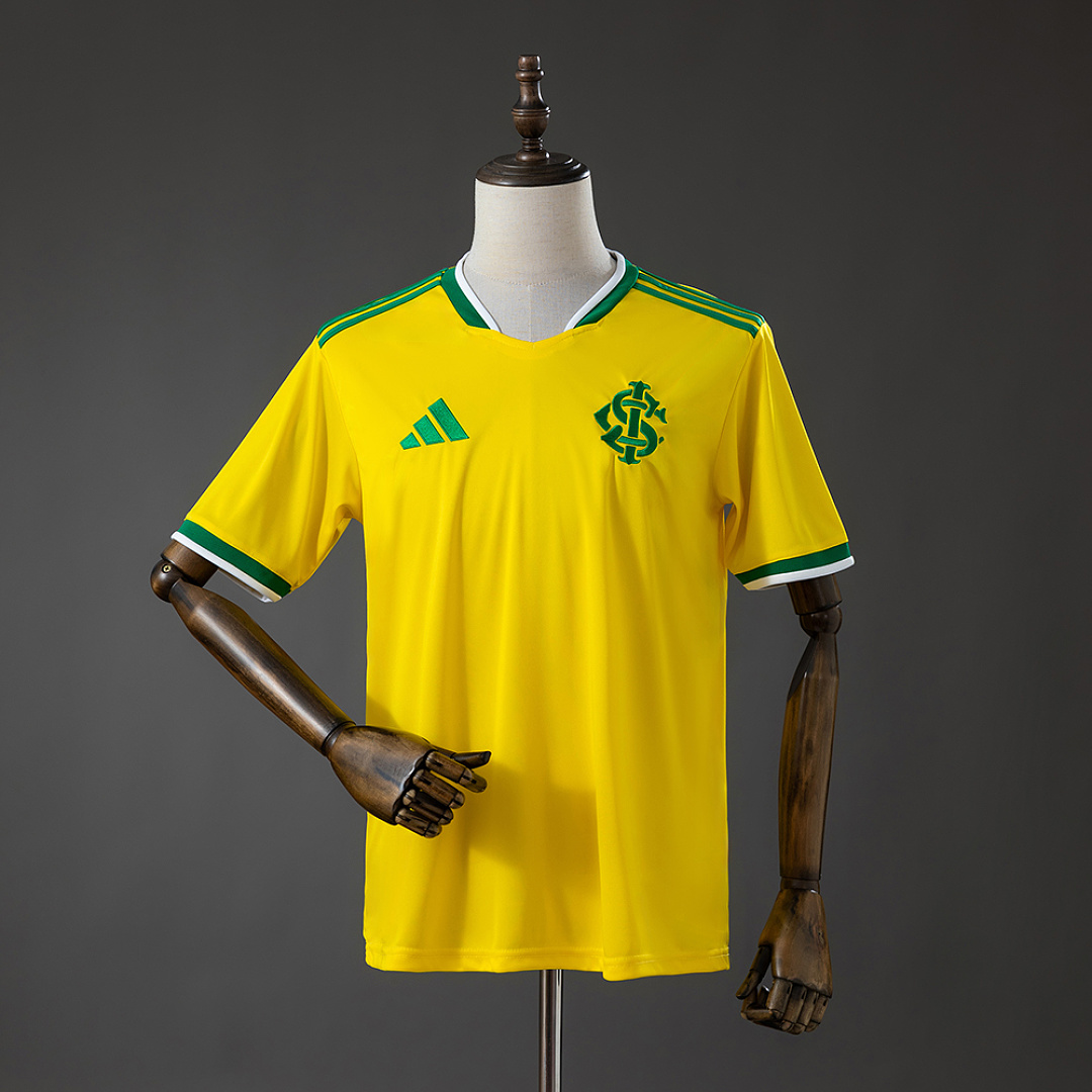 Mens Internacional Brazil Edition Jersey 2026/27 Mens Internacional Brazil Edition Jersey 2026/27 front view in yellow with green trim and SCI crest