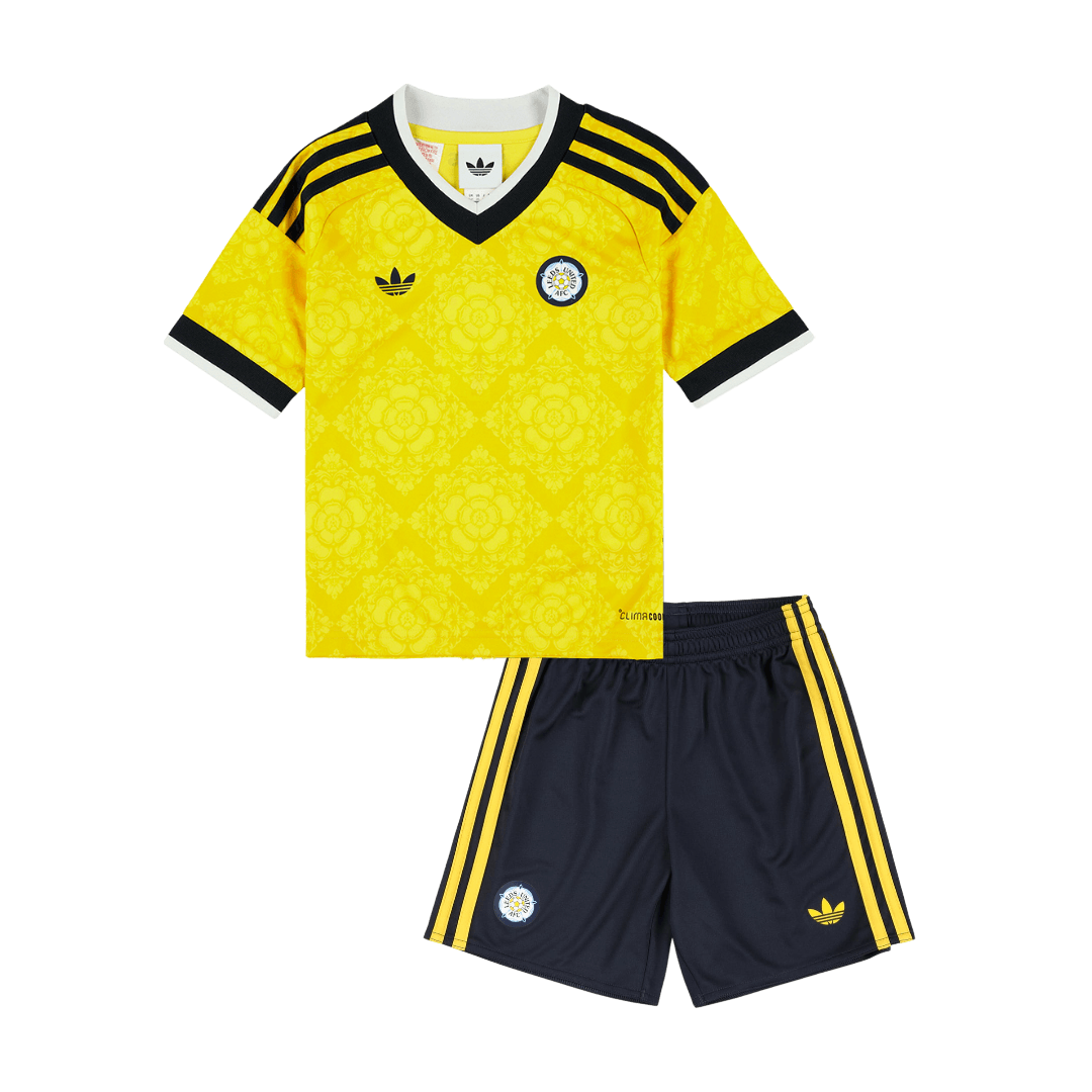 Kids Leeds United Away Kit 2026/27 Kids Leeds United Away Kit 2026/27 yellow shirt and navy shorts front view with Yorkshire Rose pattern