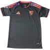 Mens Sevilla Third Jersey 2026/27 flat lay view highlighting textured black fabric and sunset-toned shoulder stripes
